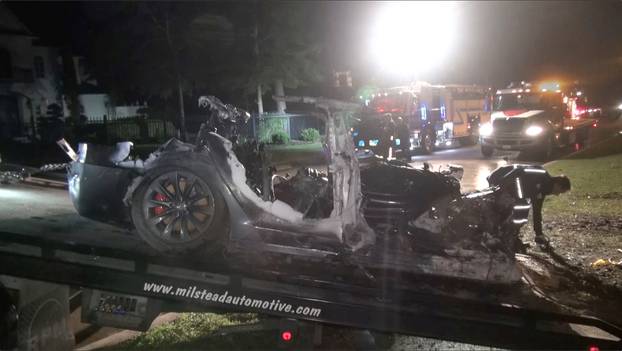 The remains of a Tesla vehicle are seen after it crashed in The Woodlands, Texas