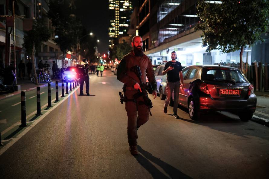 Israeli emergency services attend the scene of a suspected attack in Tel Aviv