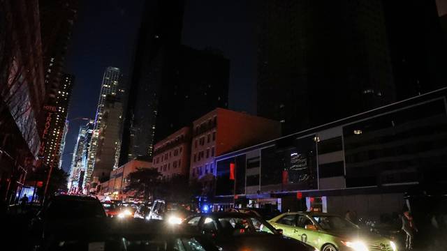 Residential buildings light out near Times Square area, as a blackout affects buildings and traffic during widespread power outages in the Manhattan borough of New York