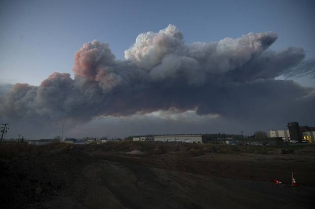 A massive plume of smoke from a wildfire north of the city stretches over Fort McMurray Alberta