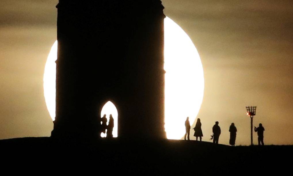 St Michael's Tower is seen on Glastonbury Tor as a full moon rises in Glastonbury