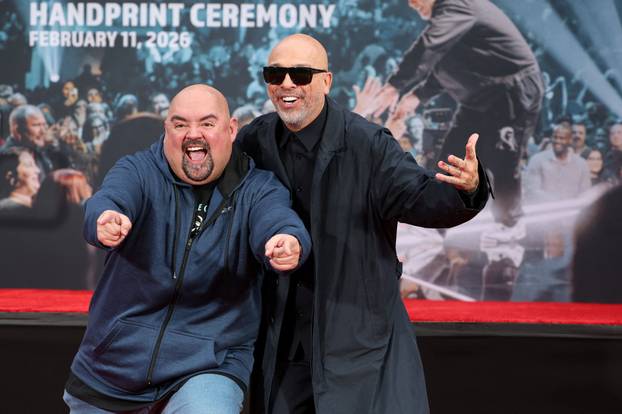 Comedian Jo Koy makes his handprints and footprints in cement, in Los Angeles