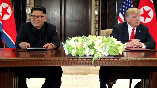 U.S. President Trump and North Korea's Kim hold a signing ceremony at the conclusion of their summit in Singapore