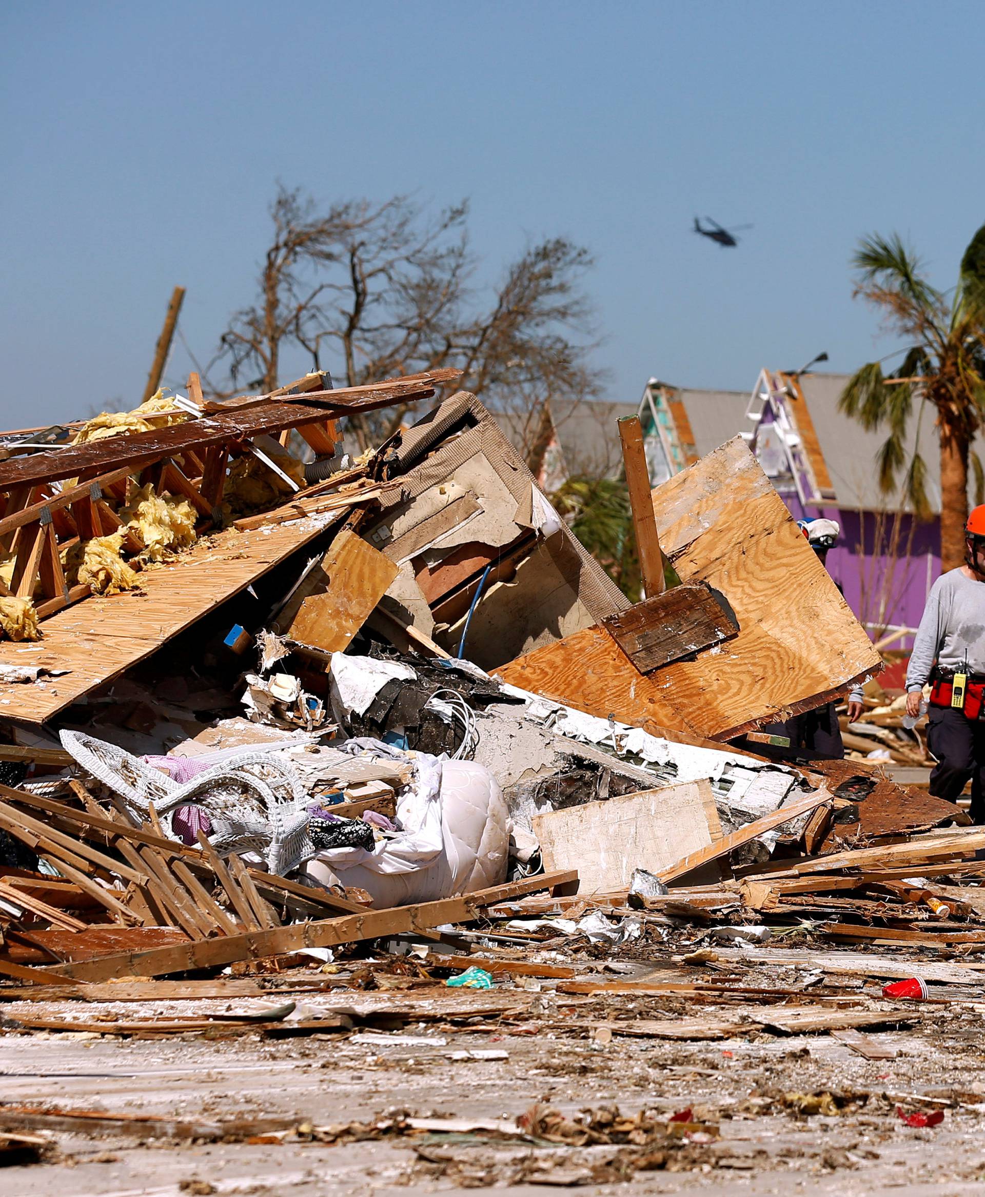 FILE PHOTO: Search and rescue crews walk past debris caused by Hurricane Michael in Mexico Beach