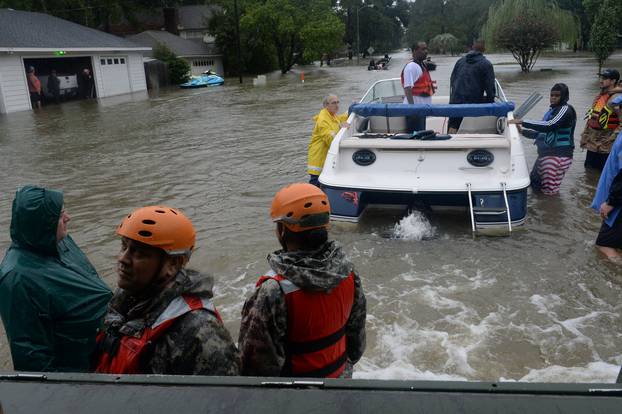 Texas National Guardsmen work alongside first responders to rescue local citizens from severe flooding in Cypress Creek
