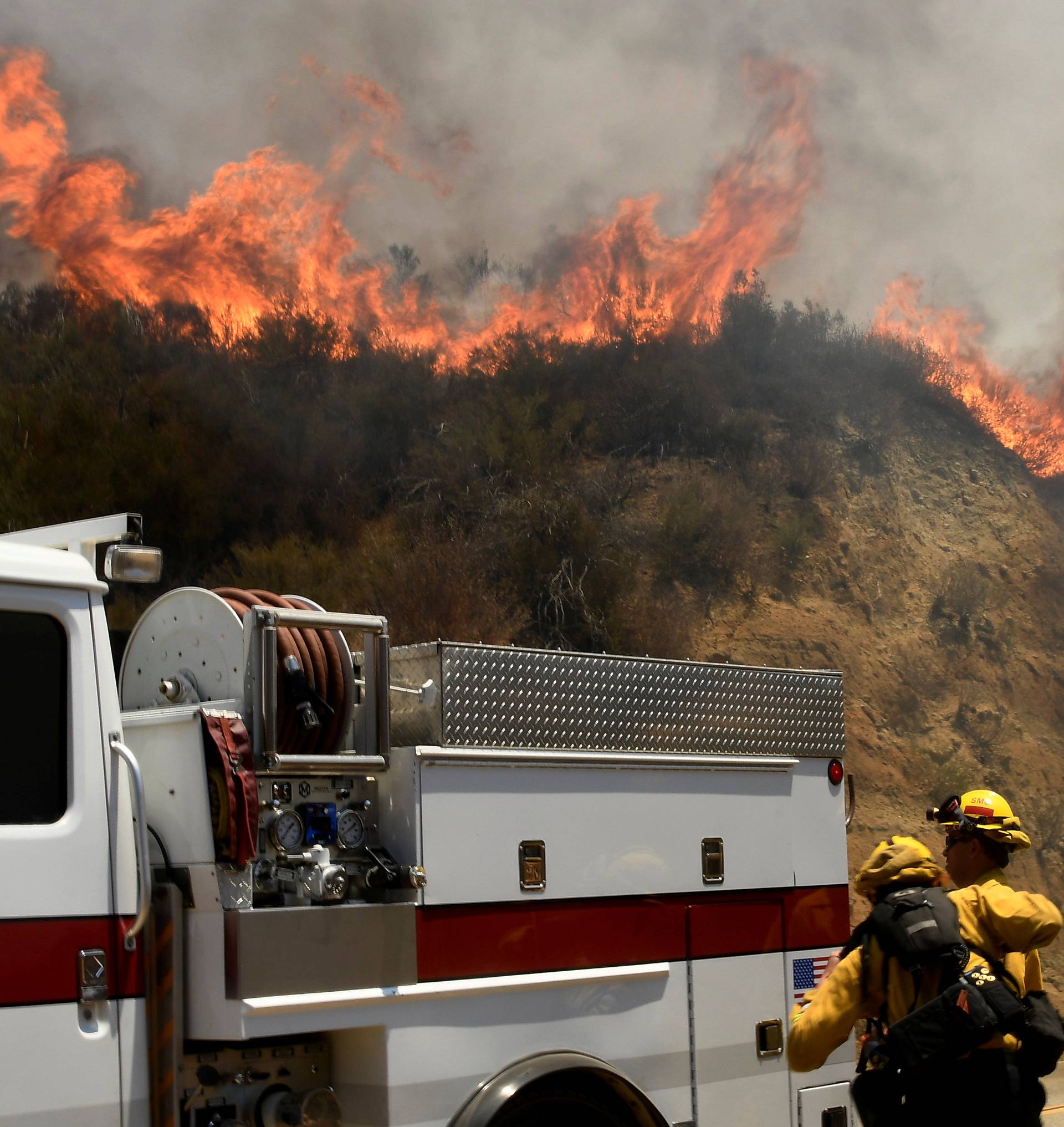 Fire fighters battle the so-called Sand Fire in the Angeles National Forest near Los Angeles, California