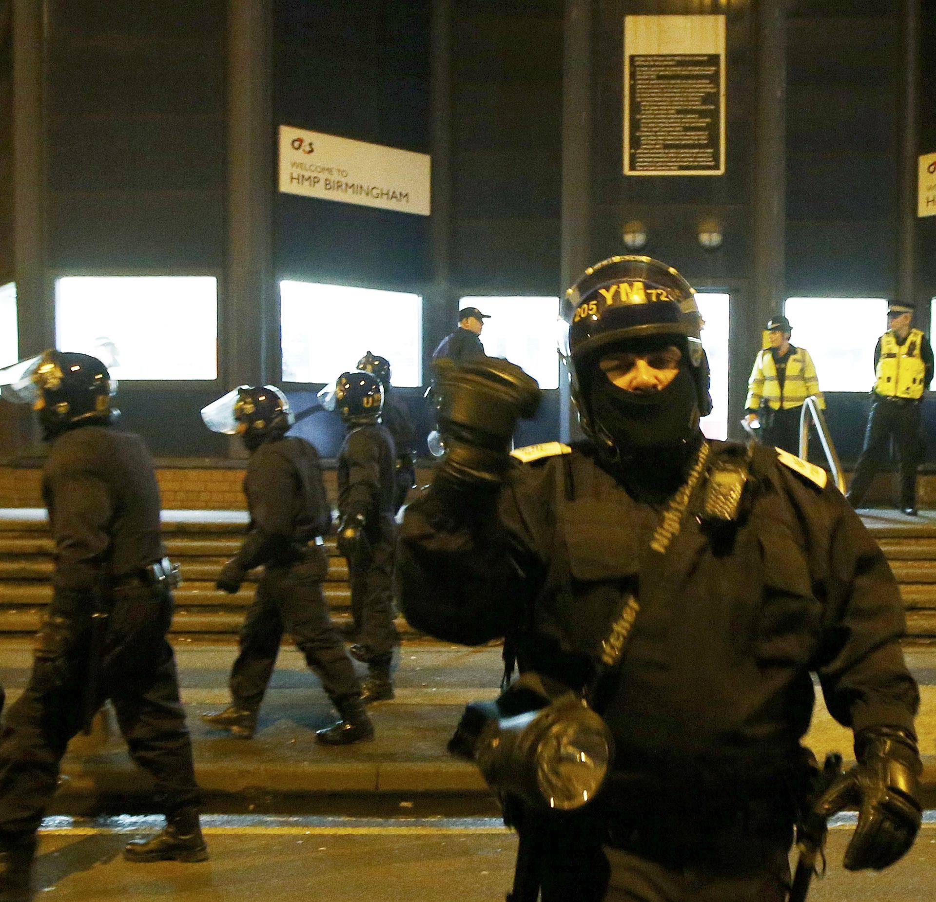 Police officers in riot gear stand outside Winson Green prison, run by security firm G4S, after a serious disturbance broke out, in Birmingham