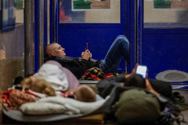 People take shelter inside a metro station during an air raid alert in Kyiv