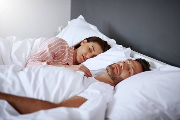 Getting a good nights rest. a middle-aged couple sleeping in bed together.