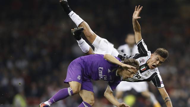 Juventus' Paulo Dybala is fouled by Real Madrid's Luka Modric