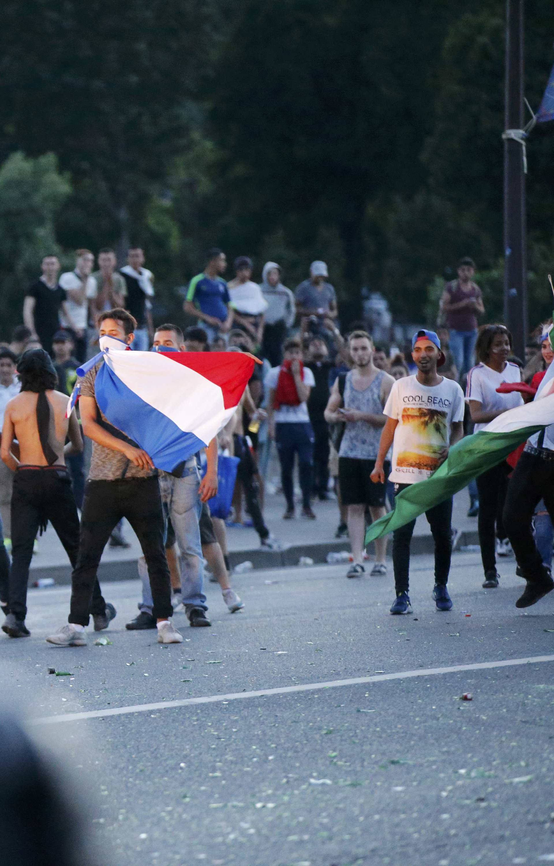 French CRS riot police hold a position during clashes outside the Paris fan zone during a EURO 2016 final soccer match       