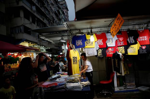 FILE PHOTO: People shop for clothes at a traditional market in Hong Kong