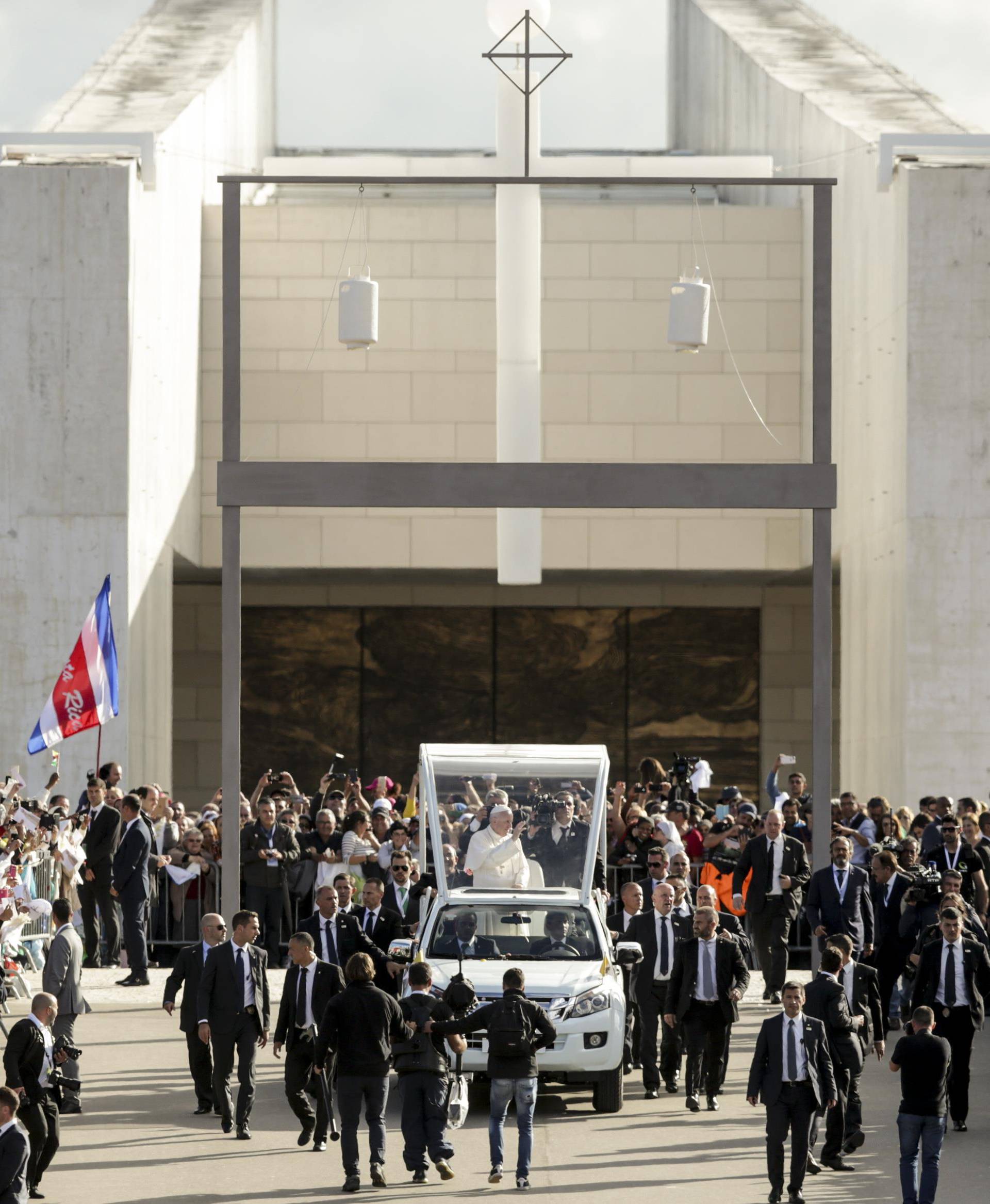 Pope Francis waves as he arrives at the Shrine of Our Lady of Fatima in Portugal