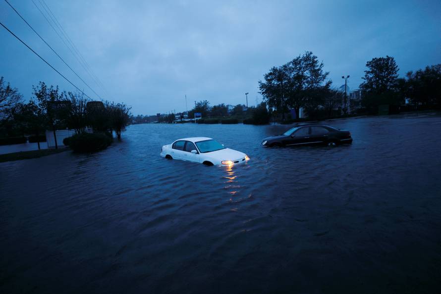 An abandoned car's hazard lights continue to flash as it sits submerged in a rising flood waters after Hurricane Florence struck in Wilmington, North Carolina
