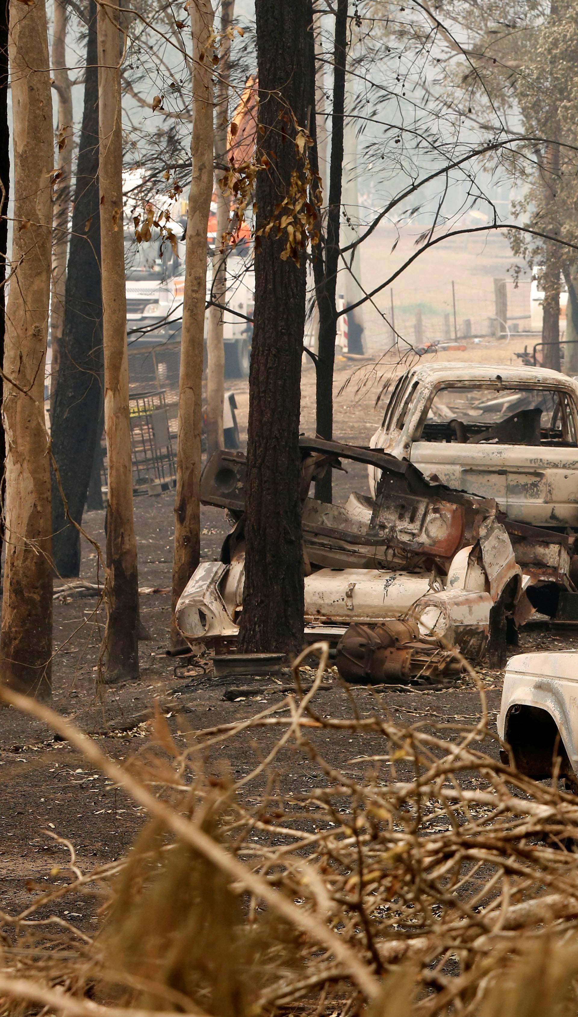 A cluster of burnt out cars sit at a property at Rainbow Flat