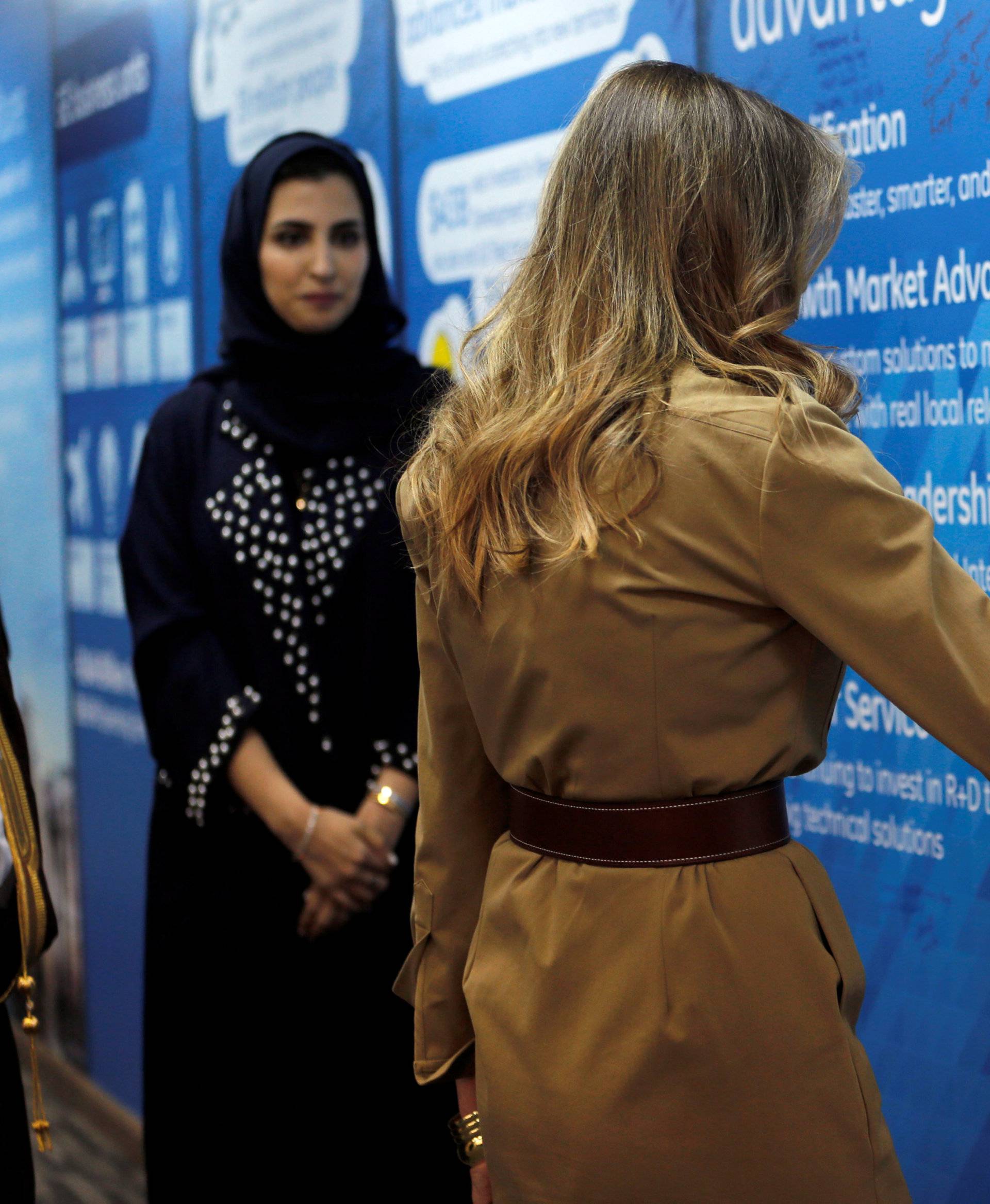 First lady Melania Trump writes as she visits GE All women business process service center in Riyadh