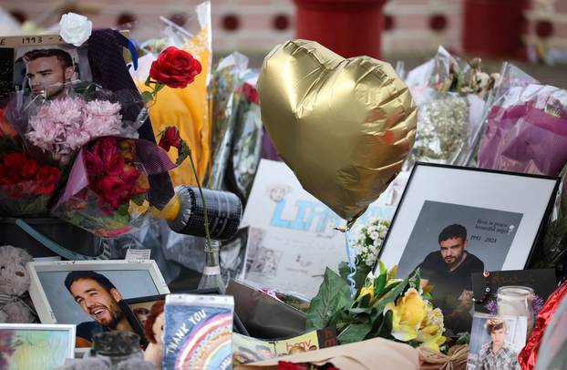 Flowers and tributes to remember former One Direction singer Liam Payne, who was found dead after he fell from a third-floor hotel room balcony in Buenos Aires, are seen in a park in his home town of Wolverhampton, Britain