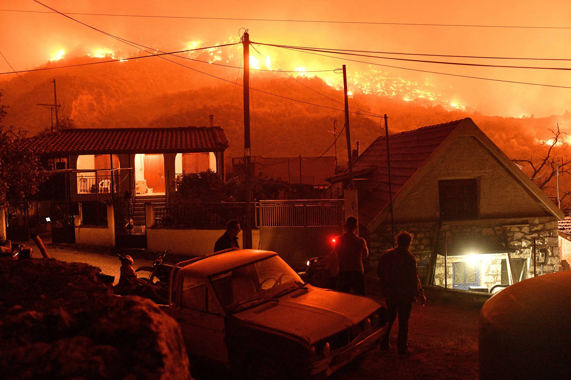 Wildfire burns next to the village of Kallithea, near Corinth