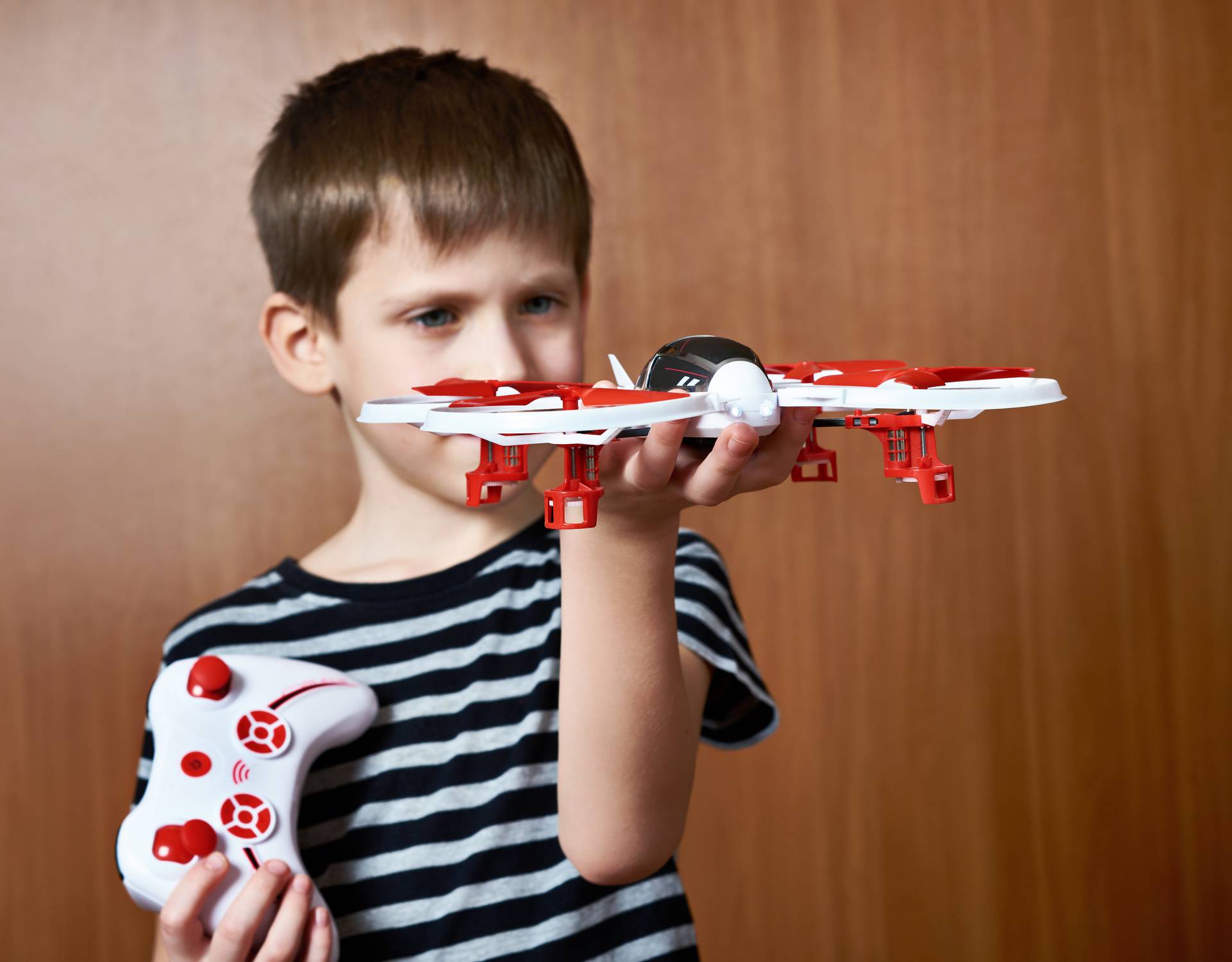 Little boy with toy quadcopter drone