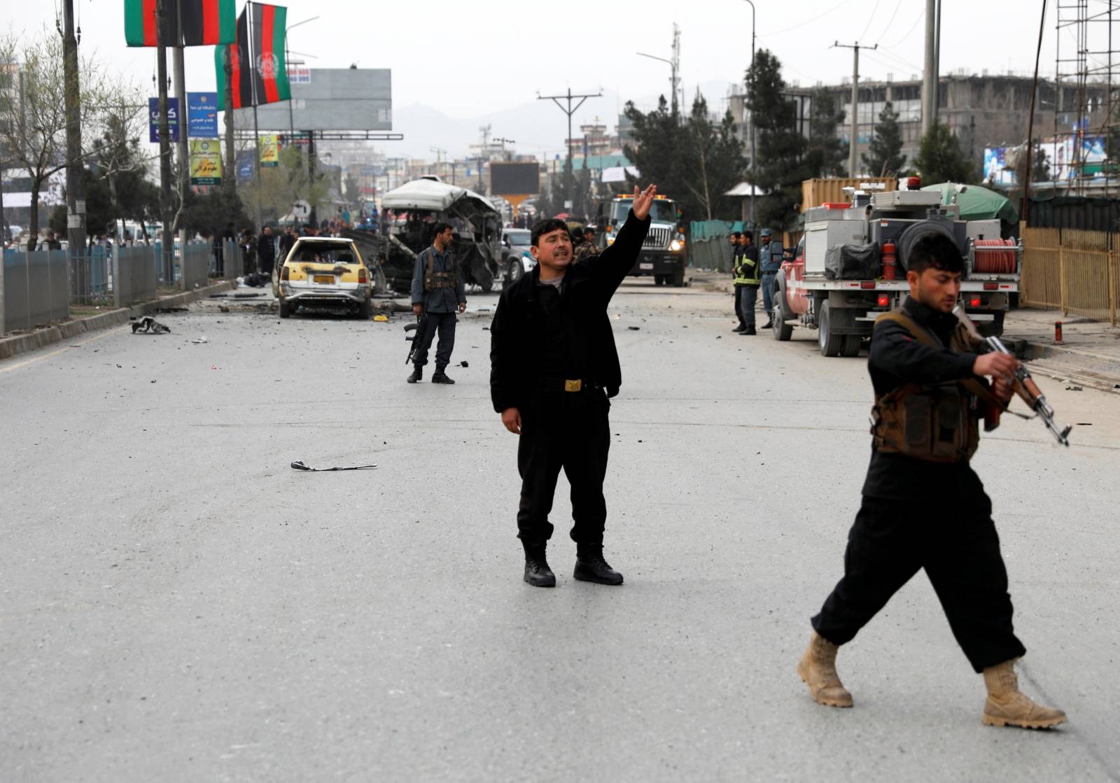 Afghan police inspect at the site of a blast in Kabul