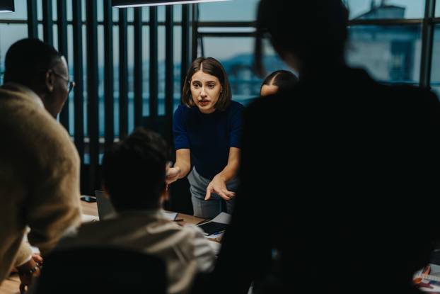 Group of business people engaged in a brainstorming session, fostering creativity and teamwork.