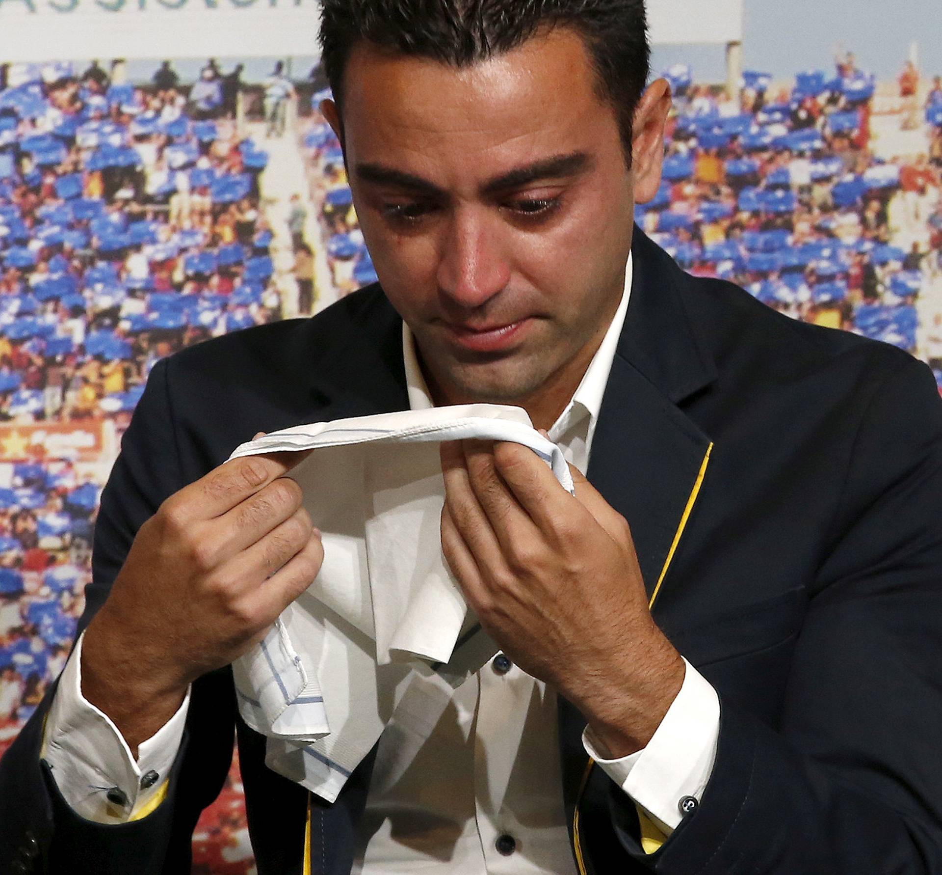 FILE PHOTO: Barcelona's Xavi Hernandez cries during his farewell event at Auditori 1899 in Nou Camp stadium in Barcelona