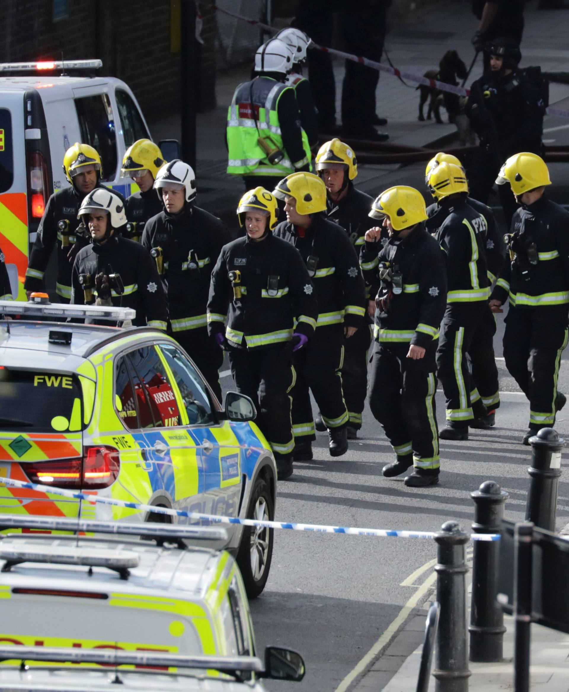 Members of the emergency services work near Parsons Green tube station in London
