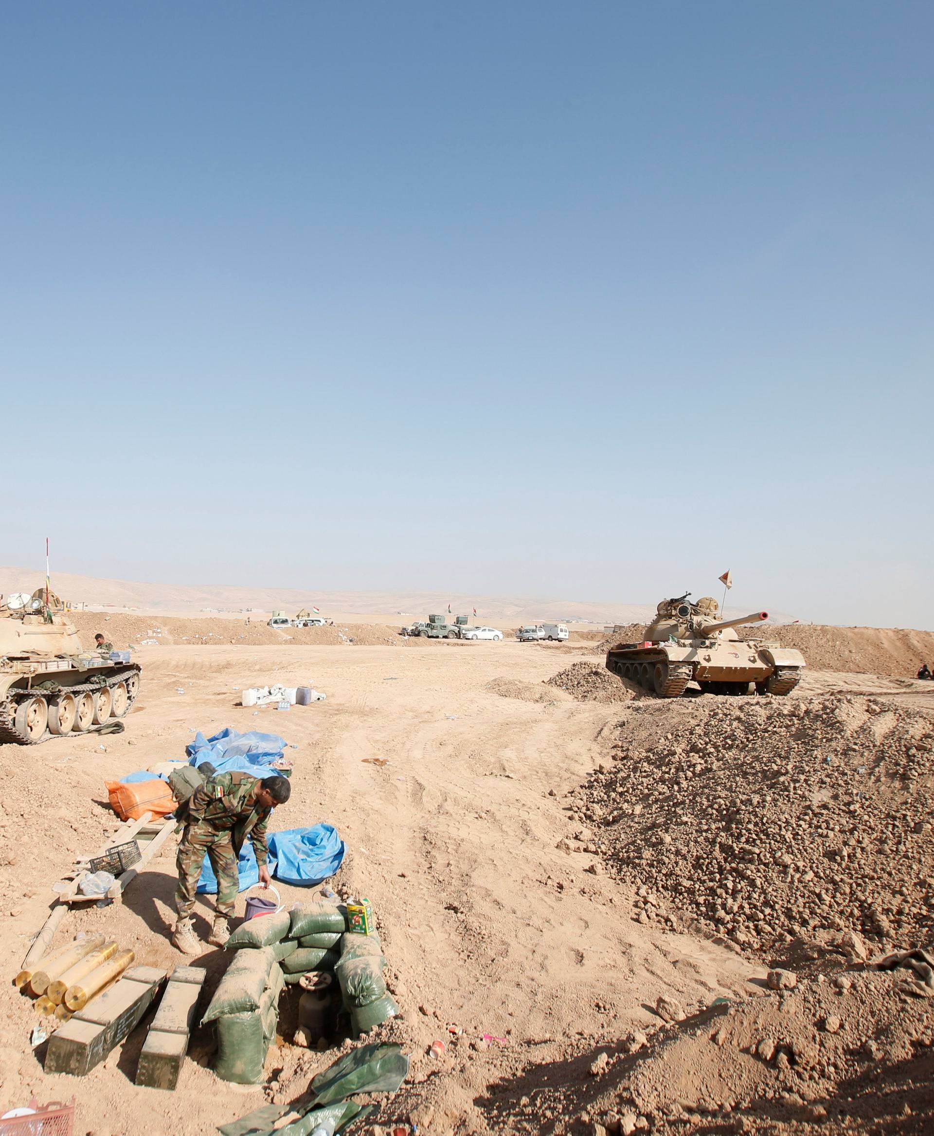 Tanks of peshmerga forces are seen on the outskirts of Bashiqa