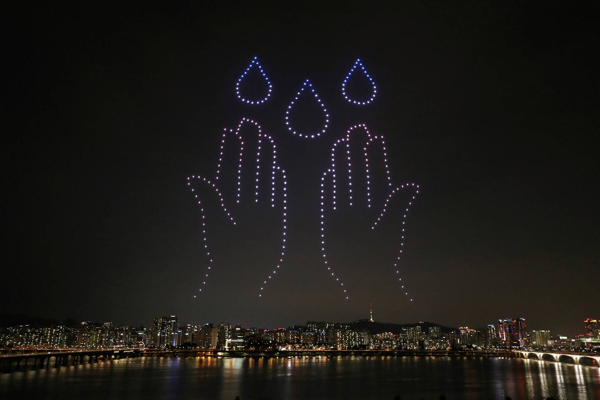 Drones fly over the Han river showing messages to support the country as measures to avoid the spread of the coronavirus disease (COVID-19) continue in Seoul