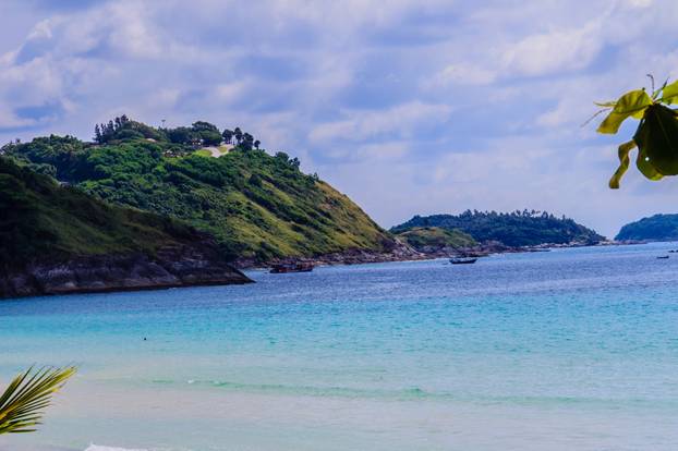 Beautiful seascape view of Nai Harn Beach Phuket with sail yacht