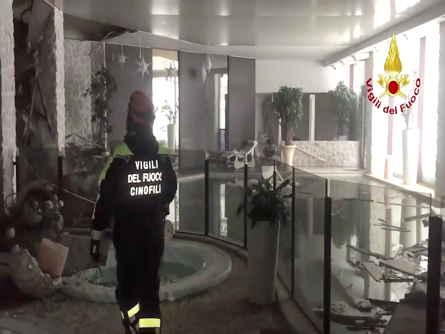 A still image taken from a video shows a firefighter working at Hotel Rigopiano in Farindola