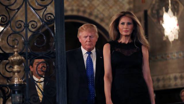 U.S. President Donald Trump, First Lady Melania Trump and Japanese Prime Minister Shinzo Abe (L) walk to pose for a photograph before attending dinner at Mar-a-Lago Club in Palm Beach, Florida, U.S.
