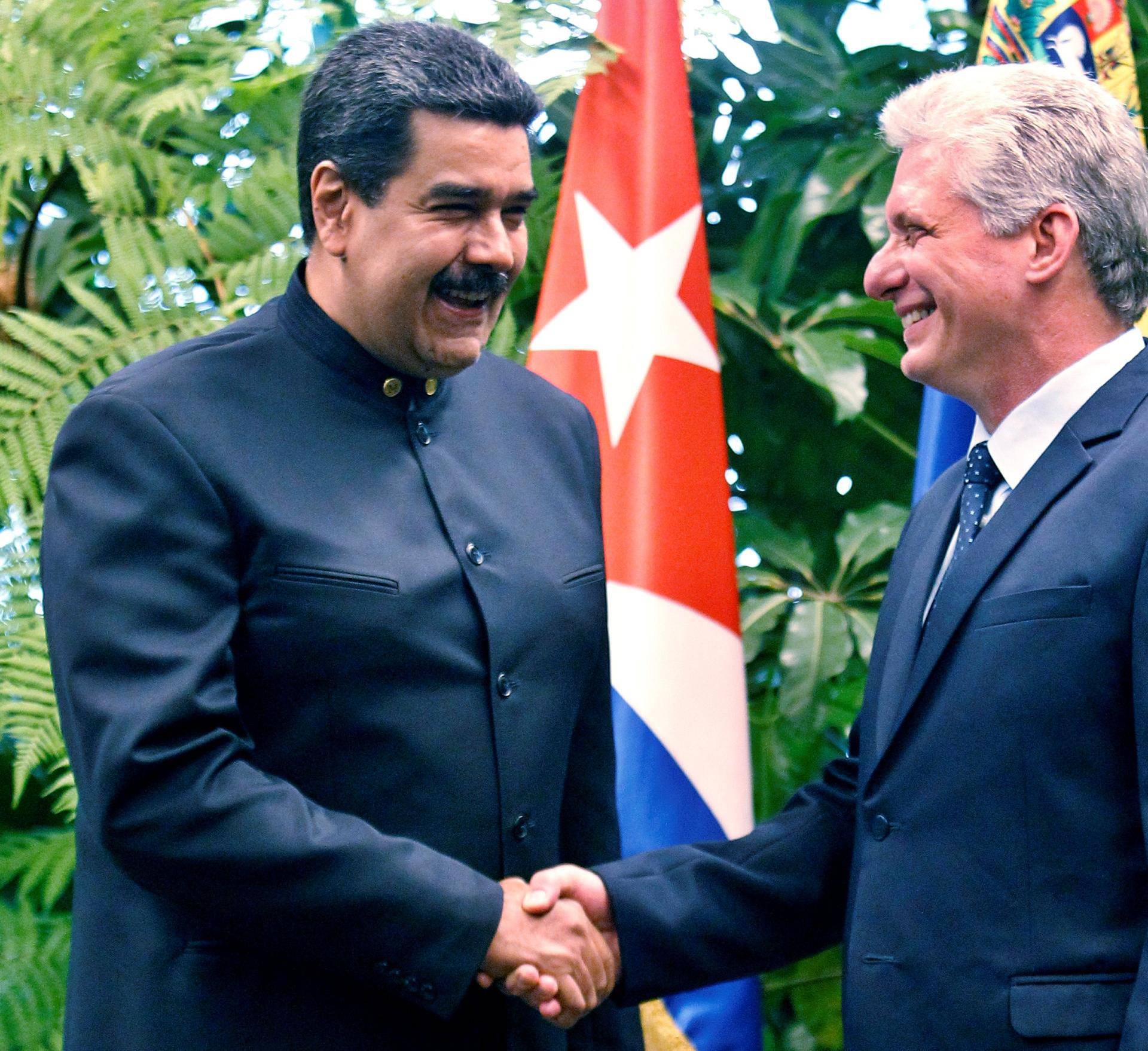 Cuban President Miguel Diaz-Canel shakes hands with Venezuela's President Nicolas Maduro at the Revolution Palace in Havana