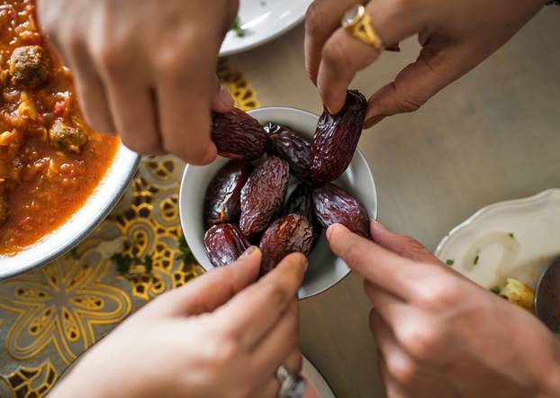 Family,Sharing,A,Bowl,Of,Dates