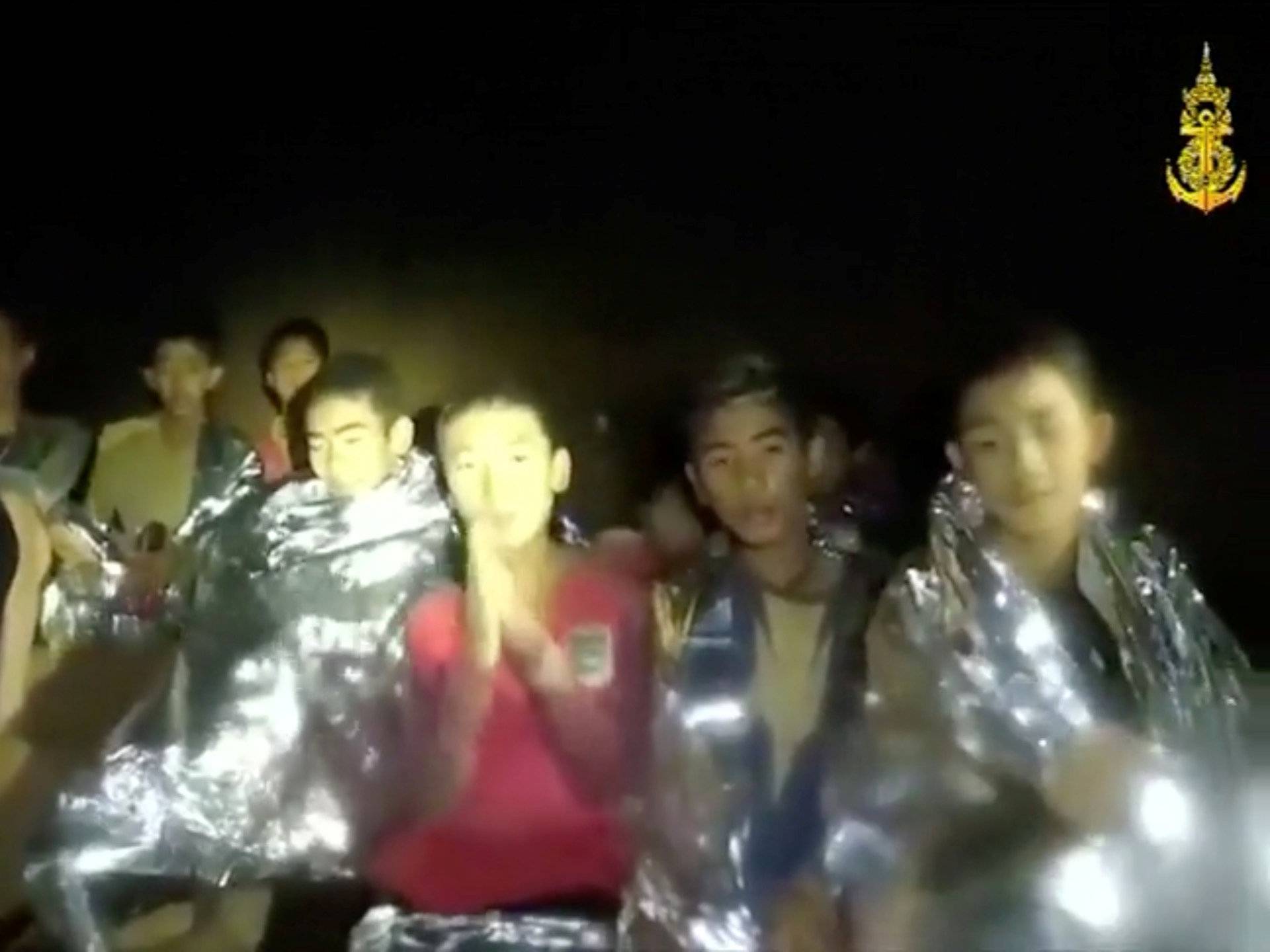 Boys from the under-16 soccer team trapped inside Tham Luang cave greet members of the Thai rescue team in Chiang Rai, Thailand