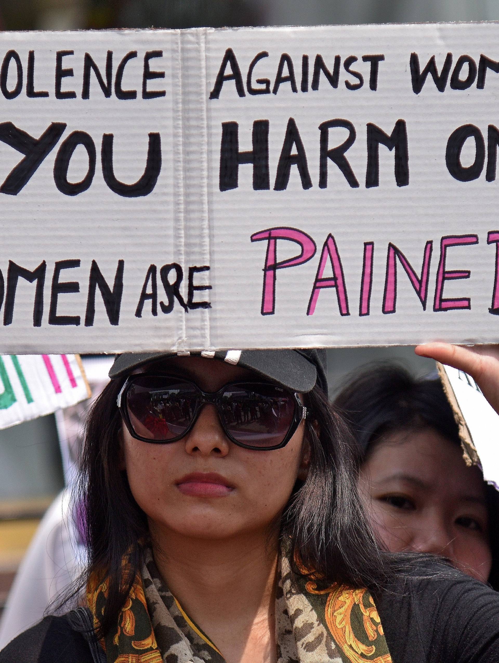 A woman holds a placard during a protest against the rape of an eight-year-old girl in Kathua, near Jammu, in Guwahati