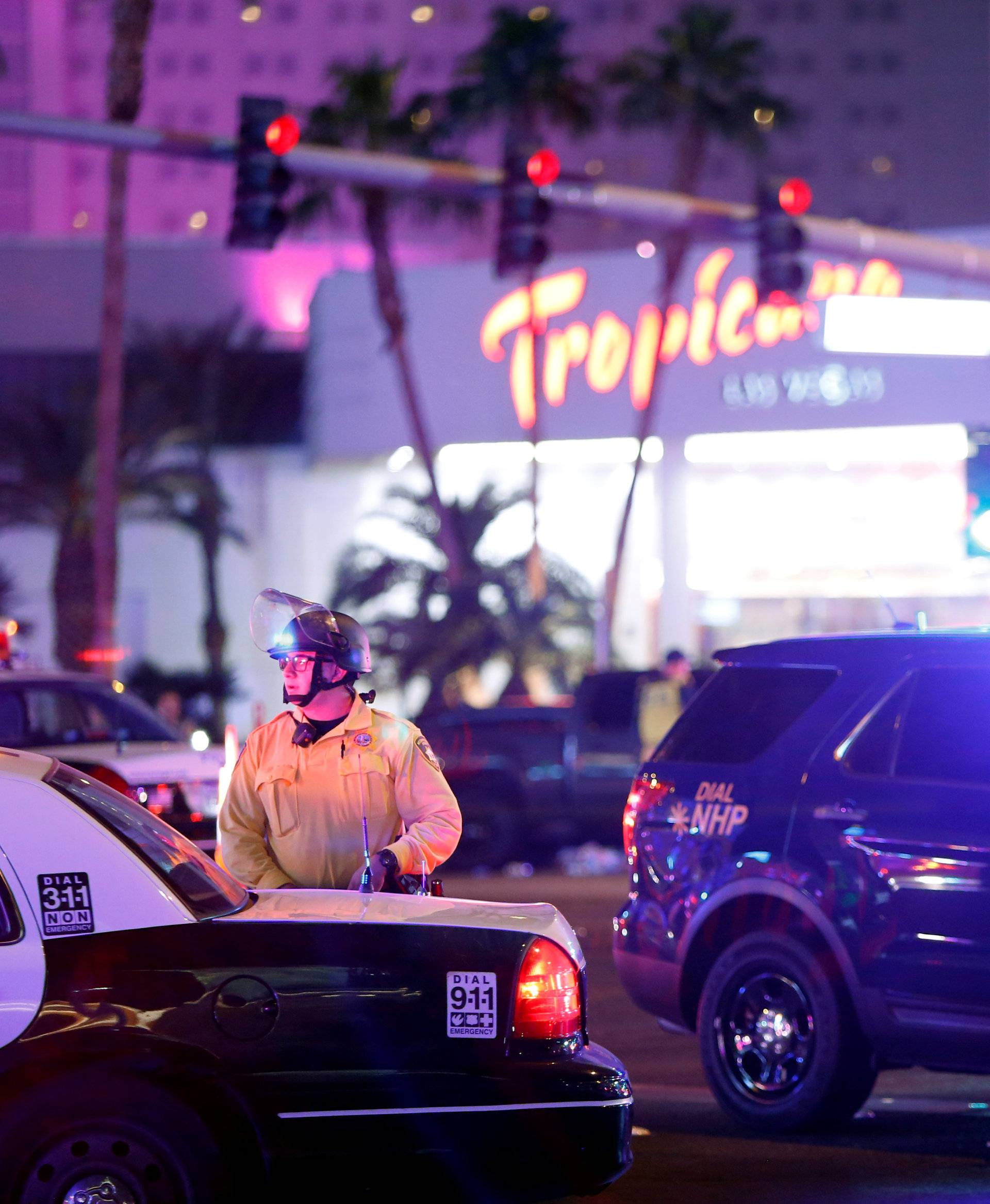Las Vegas Metro Police officer stands by at a staging area in the intersection of Tropicana Avenue and Las Vegas Boulevard South after a mass shooting at a music festival on the Las Vegas Strip in Las Vegas