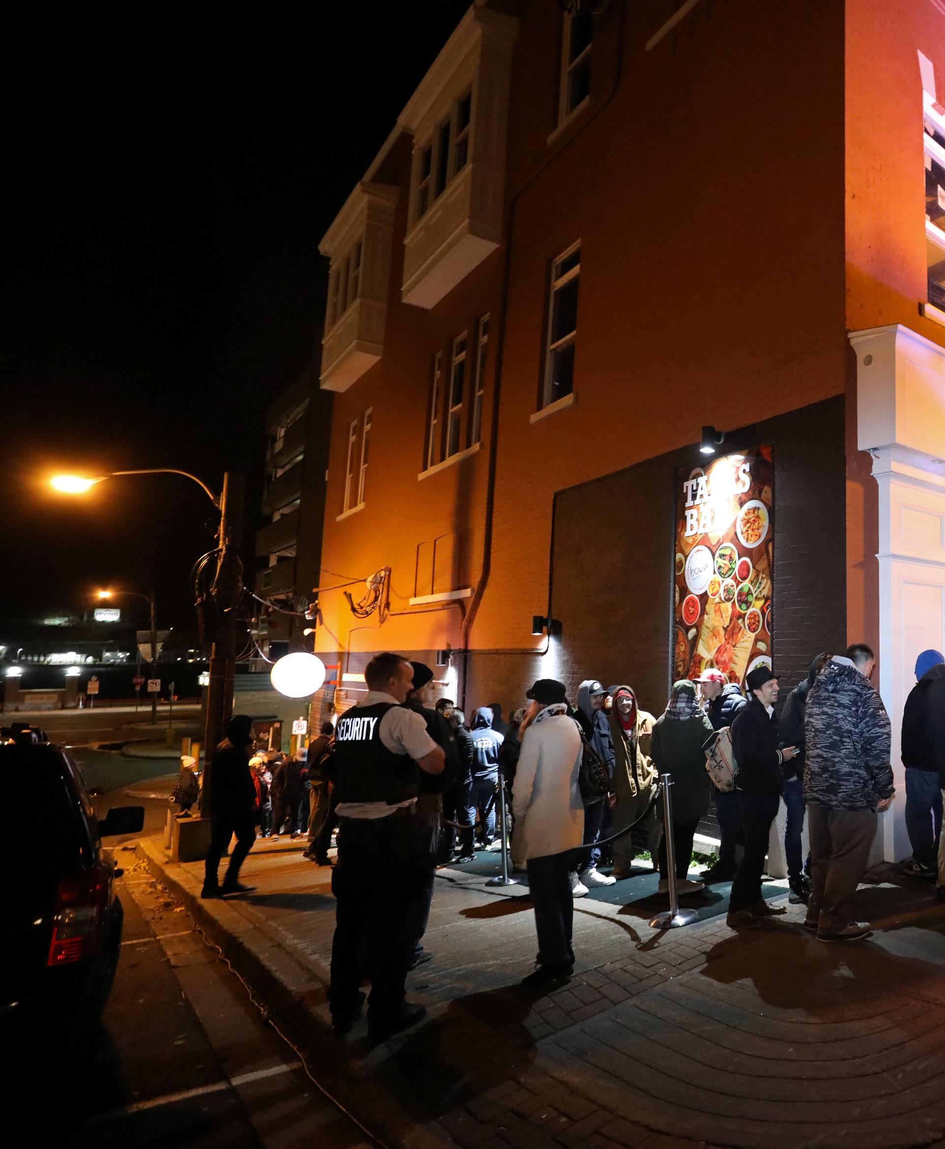 Customers line up to purchase the first legal recreational marijuana that will go on sale after midnight at a Tweed retail store in St John's