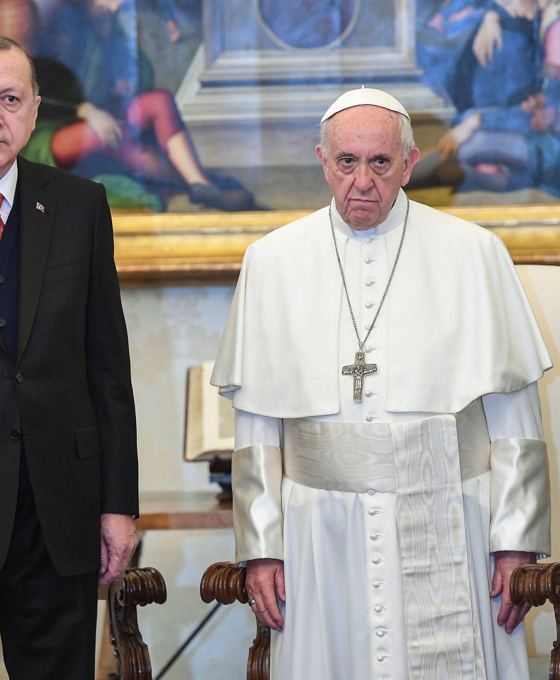 Pope Francis poses with Turkish President Tayyip Erdogan and his wife Emine during a private audience at the Vatican