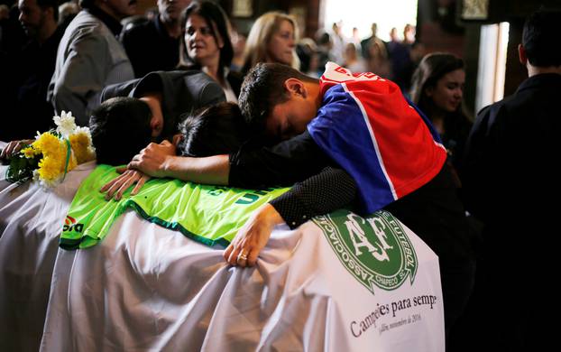 Relatives of Chapecoense soccer club head coach Caio Junior, who died in the plane crash in Colombia, participate in a ceremony to pay tribute to him in Curitiba