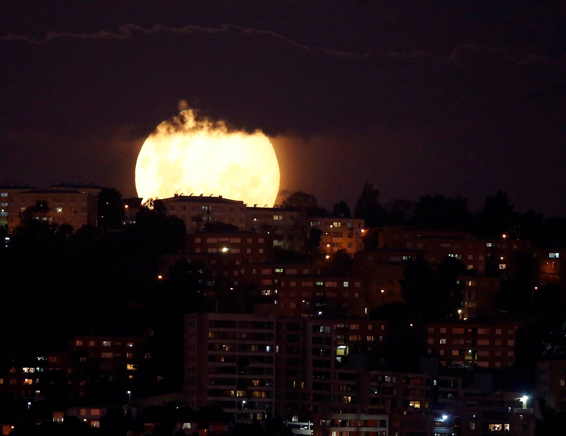 A supermoon rises in the sky at the city of Vina del Mar