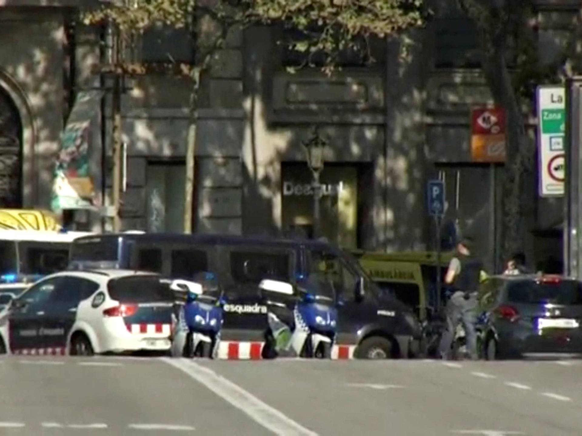 A still image from video shows a police cordon on a street in Barcelona, Spain following a van crash