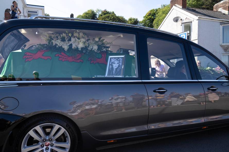 Crowds line the route in Mumbles as Bonnie Tyler's coffin makes its way to Skewen, Wales. August 15th 2026