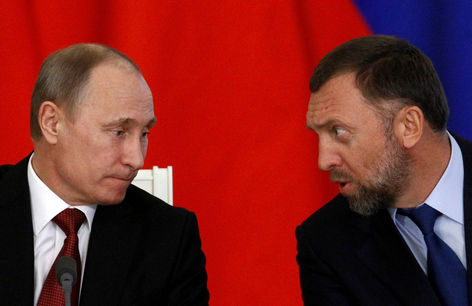 FILE PHOTO: Russia's President Vladimir Putin and Russian tycoon Oleg Deripaska attend a signing ceremony after talks with the Chinese delegation at the Kremlin in Moscow