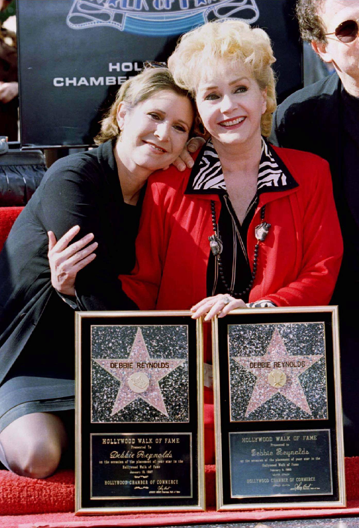 FILE PHOTO: Actress Debbie Reynolds poses with her daughter actress Carrie Fisher (L) after Reynolds star in the live theatre and stage category