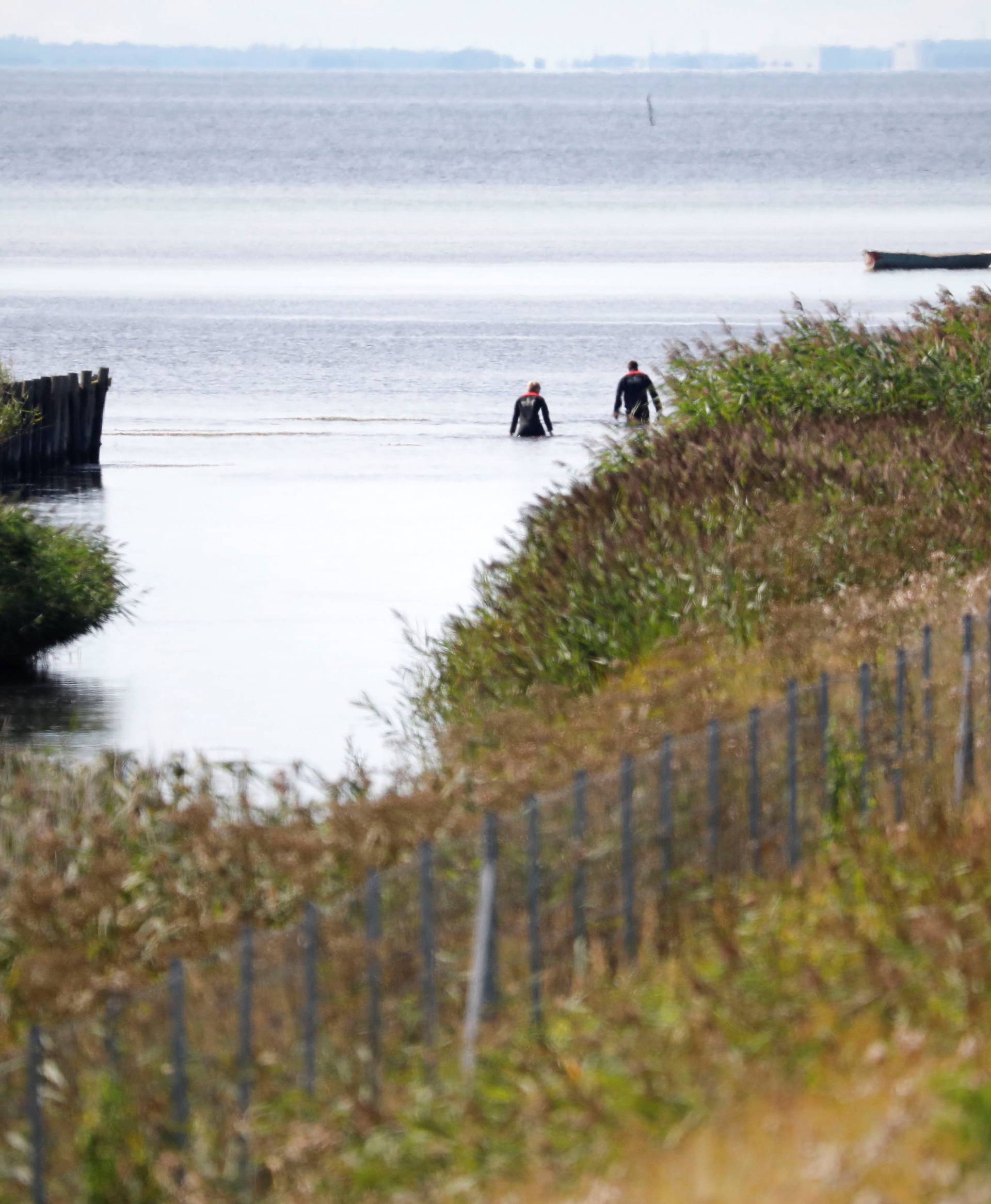 Members of the Danish Emergency Management Agency (DEMA) (Danish: Beredskabsstyrelsen) assist police at Kalvebod Faelled in search of missing body parts of journalist Kim Wall close to the site where her torso was found, in Copenhagen