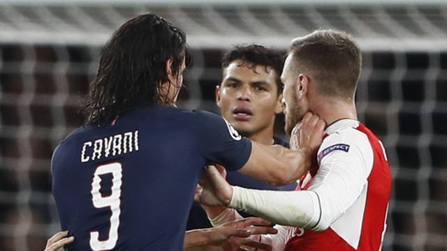 Paris Saint-Germain's Edinson Cavani clashes with Arsenal's Aaron Ramsey as Thiago Silva looks on