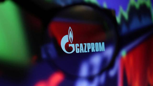 FILE PHOTO: Illustration shows Gazprom logo and stock graph