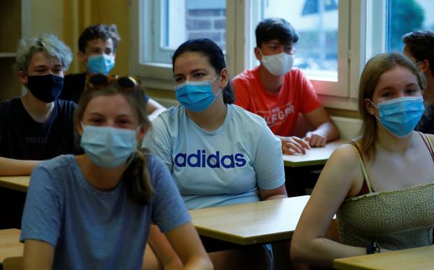 Pupils of the protestant high school "Zum Grauen Kloster" attend a lesson on the first day after the summer holidays in Berlin