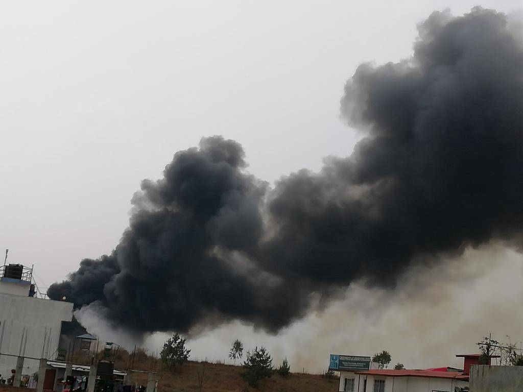 Smoke rises following the crash of a Bangladeshi aircraft at Kathmandu airport